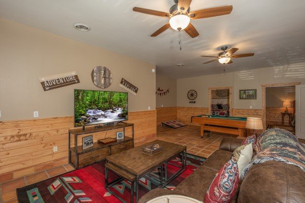 Living room with pool table at Hawk’s Heart Lodge, a 3 bedroom cabin rental located in Pigeon Forge