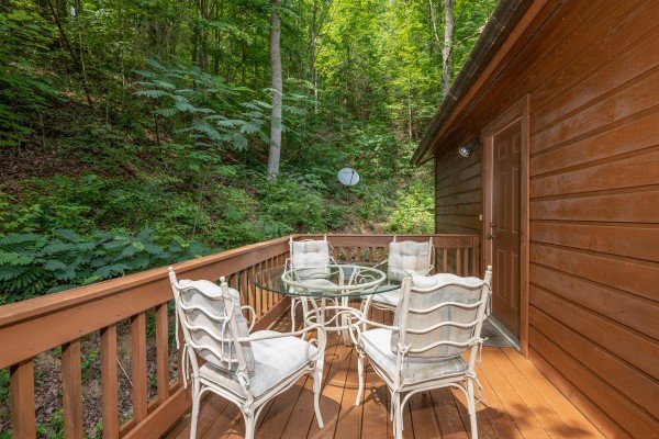Outdoor dining set for four at Hawk’s Heart Lodge, a 3 bedroom cabin rental located in Pigeon Forge