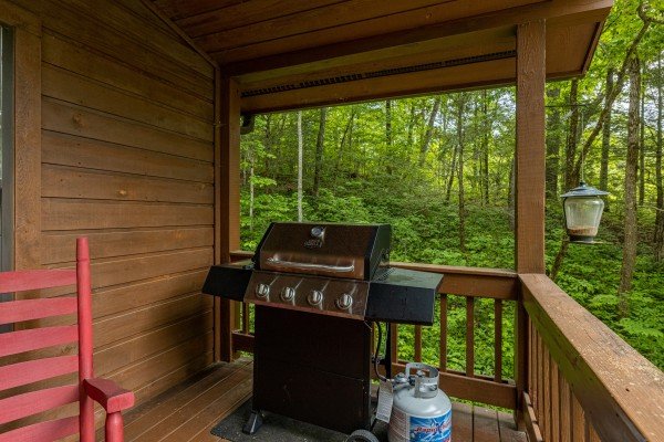 Grill on a covered deck at Hawk’s Heart Lodge, a 3 bedroom cabin rental located in Pigeon Forge