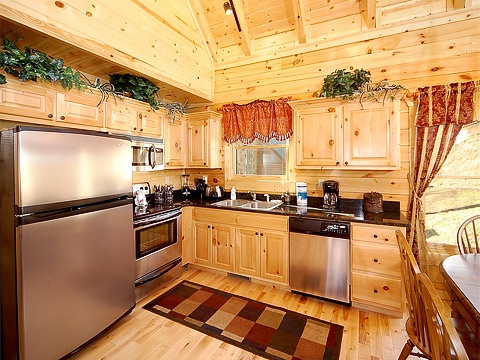kitchen with stainless steel appliances at natural wonder a 4 bedroom cabin rental located in gatlinburg