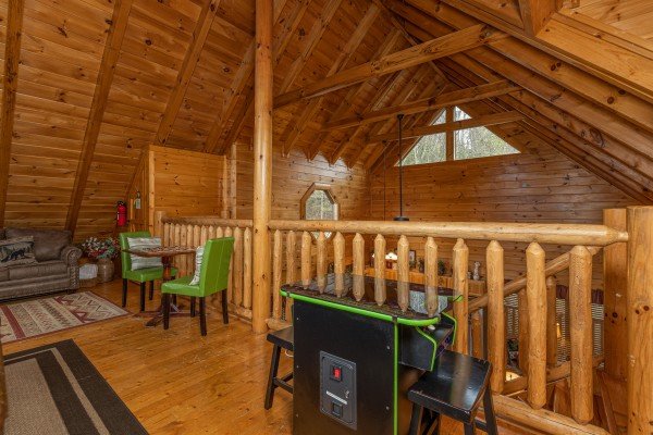 Arcade game in the loft at Absolutely Wonderful, a 2 bedroom cabin rental located in Pigeon Forge