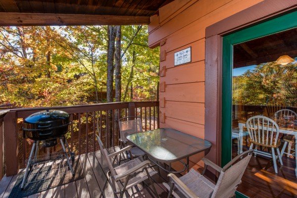 Grill on the covered deck at Hawk's Nest, a 1 bedroom cabin rental located in Pigeon Forge