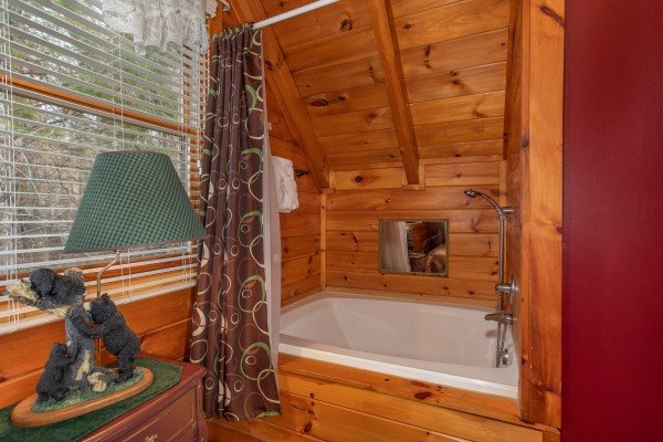 A jacuzzi tub with a shower head on the upper floor at Shiloh, a 3 bedroom cabin rental located in Gatlinburg