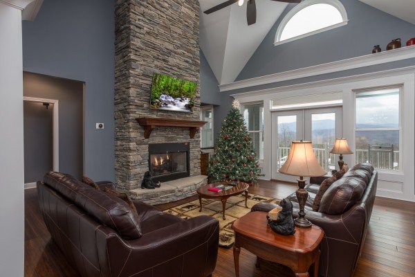 Fireplace, TV, and mountain view in the living room at Summit Glory, a 5 bedroom cabin rental located in Pigeon Forge