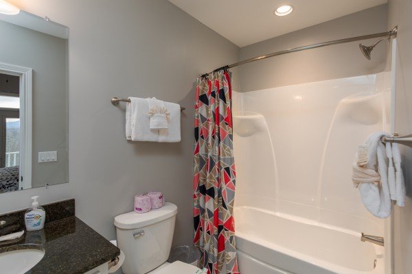 Bathroom with a tub and shower at Summit Glory, a 5 bedroom cabin rental located in Pigeon Forge