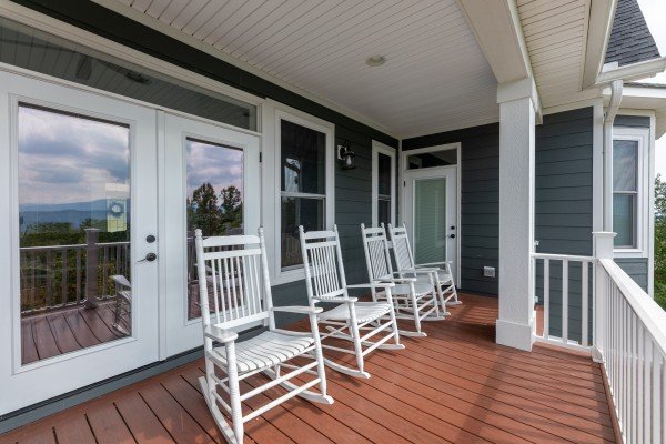 White rocking chairs on a deck at Summit Glory, a 5 bedroom cabin rental located in Pigeon Forge