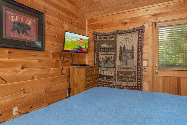 Dresser and TV in a bedroom at Moonlight in the Boondocks, a 2 bedroom cabin rental located in Gatlinburg