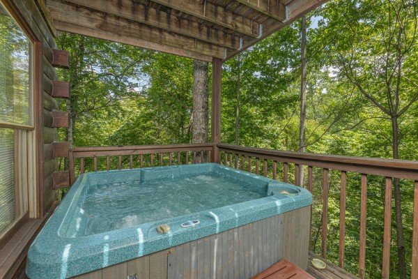 Covered hot tub deck at Moonlight in the Boondocks, a 2 bedroom cabin rental located in Gatlinburg