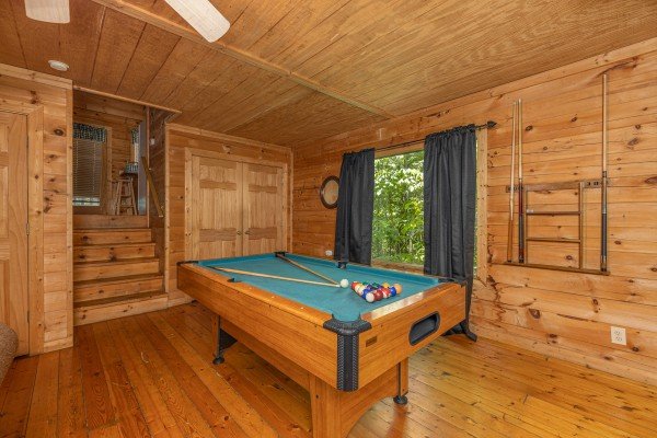 Pool table in the living room at Moonlight in the Boondocks, a 2 bedroom cabin rental located in Gatlinburg