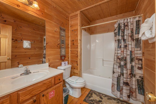 Bathroom with a tub and shower at Moonlight in the Boondocks, a 2 bedroom cabin rental located in Gatlinburg
