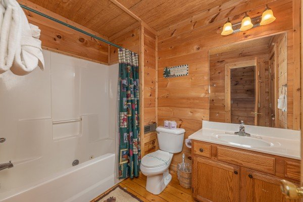 Bathroom with a tub and shower at Moonlight in the Boondocks, a 2 bedroom cabin rental located in Gatlinburg