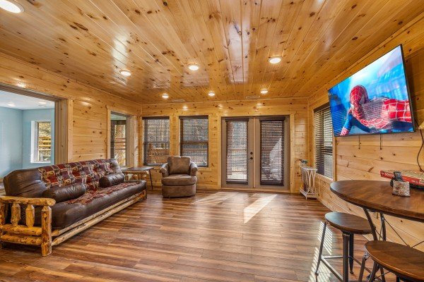 Family room with large flat screen at Swimmin' Hole In 1, a 2 bedroom cabin rental located in Gatlinburg 