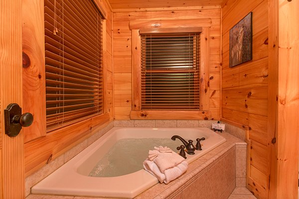 Corner jacuzzi tub at Bearfoot Paradise, a 3-bedroom cabin rental located in Pigeon Forge