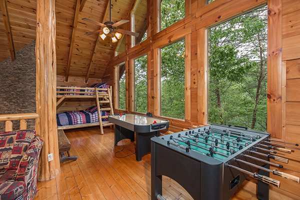 Bunks and foosball table and air hockey table at Bearfoot Paradise, a 3-bedroom cabin rental located in Pigeon Forge