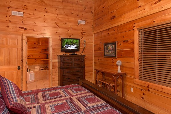 Bedroom in the loft with a television and dresser at Bearfoot Paradise, a 3-bedroom cabin rental located in Pigeon Forge