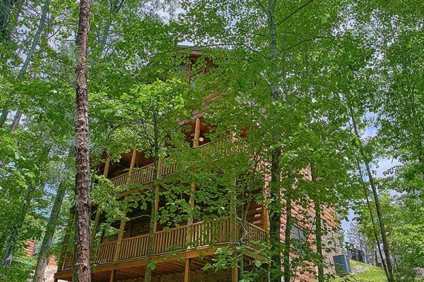 Wooded exterior view looking up at the cabin at Bearfoot Paradise, a 3-bedroom cabin rental located in Pigeon Forge
