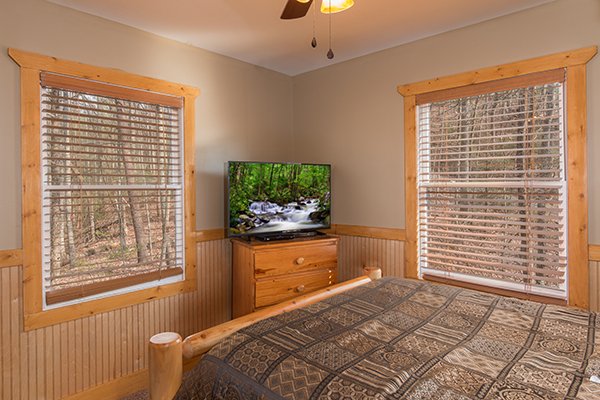 Bedroom with a dresser and TV at Lucky Logs, a 3 bedroom cabin rental located in Gatlinburg