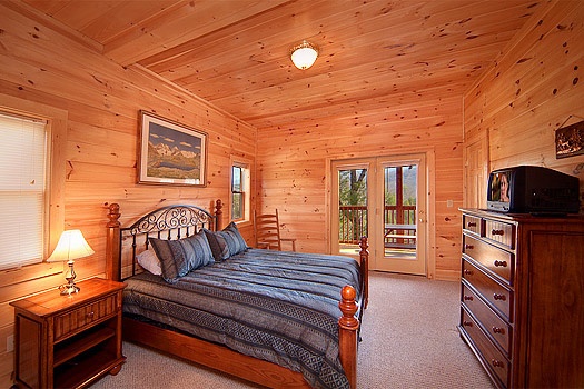 Bedroom with patio doors to deck at Highlander, a 4 bedroom cabin rental located in Gatlinburg