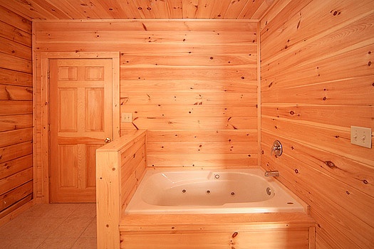 One of four jacuzzi tubs in bathrooms at Highlander, a 4 bedroom cabin rental located in Gatlinburg