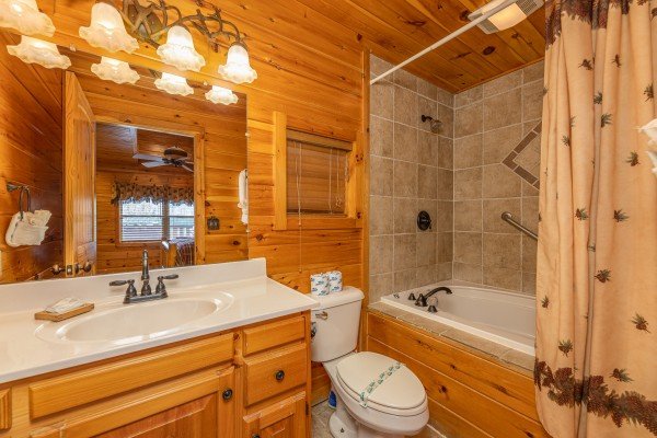 Bathroom with a jacuzzi and shower at Rainbow's End, a 4 bedroom cabin rental located in Pigeon Forge
