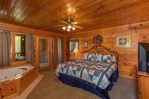 Bedroom with king bed and jacuzzi at Hillside Haven, a 1 bedroom cabin rental located in Pigeon Forge