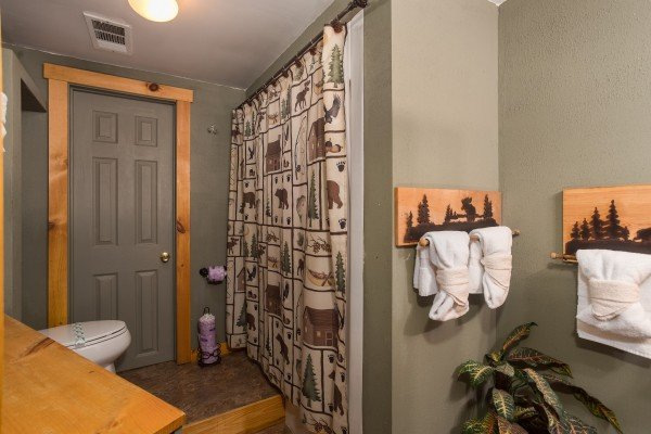 Bathroom with a tub and shower at Breezy Mountain Lodge, an 11-bedroom cabin rental located in Pigeon Forge