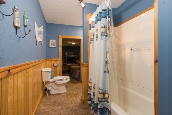 Bathroom with a tub and shower at Breezy Mountain Lodge, an 11-bedroom cabin rental located in Pigeon Forge