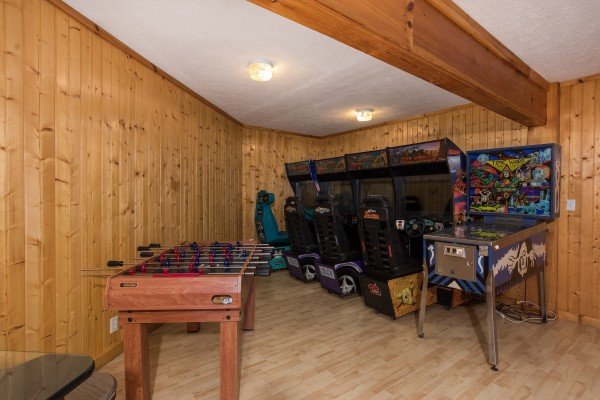 Lots of arcade games and a foosball table at Breezy Mountain Lodge, an 11-bedroom cabin rental located in Pigeon Forge