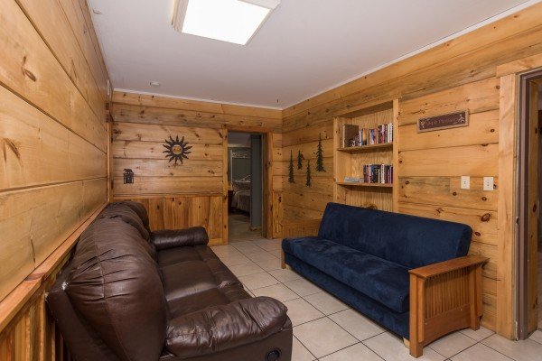 Two futons near the game room at Breezy Mountain Lodge, an 11-bedroom cabin rental located in Pigeon Forge