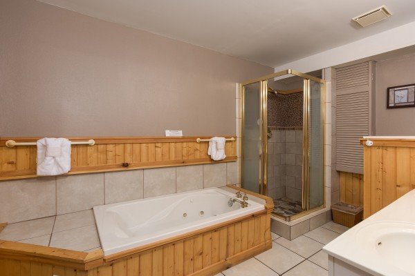Bathroom with a jacuzzi tub and separate walk-in shower at Breezy Mountain Lodge, an 11-bedroom cabin rental located in Pigeon Forge