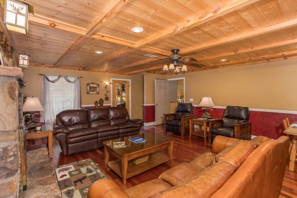 Two sofas and two recliners in the living room at Breezy Mountain Lodge, an 11-bedroom cabin rental located in Pigeon Forge