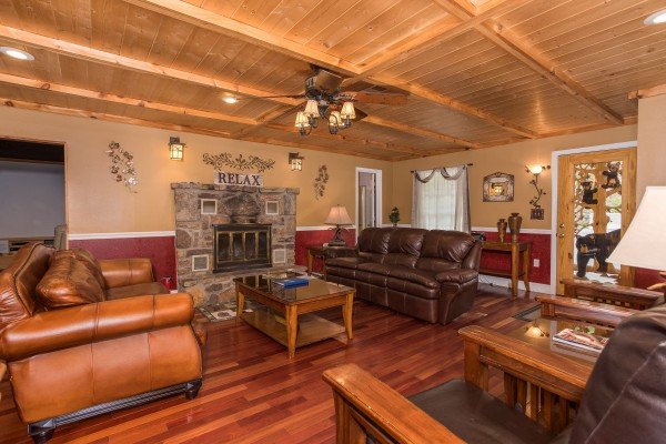 Two sofas and a chair in the main living room at Breezy Mountain Lodge, an 11-bedroom cabin rental located in Pigeon Forge