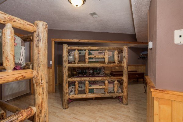 Queen-sized log bunk beds in a room at Breezy Mountain Lodge, an 11-bedroom cabin rental located in Pigeon Forge
