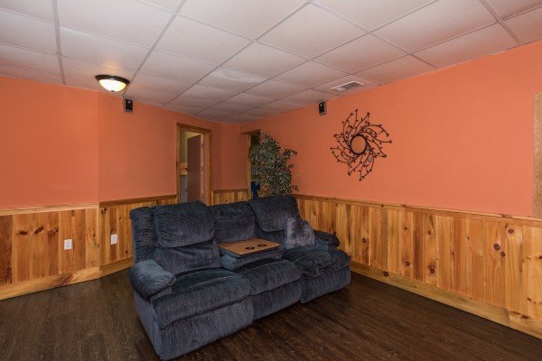 Recliner sofa with a built in table at Breezy Mountain Lodge, an 11-bedroom cabin rental located in Pigeon Forge