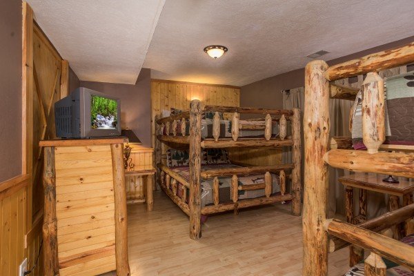 Bedroom with three queen-sized bunk bed sets at Breezy Mountain Lodge, an 11-bedroom cabin rental located in Pigeon Forge