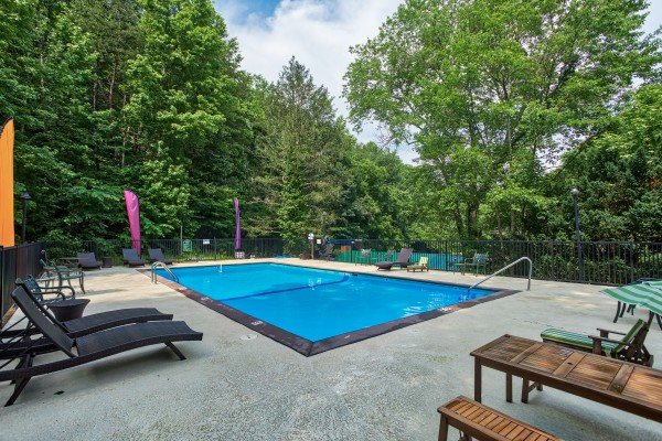 Outdoor pool with chaise lounge chairs Shagbark; Breezy Mountain Lodge, an 11-bedroom cabin rental located in Pigeon Forge