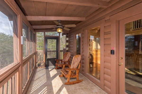 Screened in deck with rocking chairs at Leconte View Lodge, a 3 bedroom cabin rental located in Pigeon Forge
