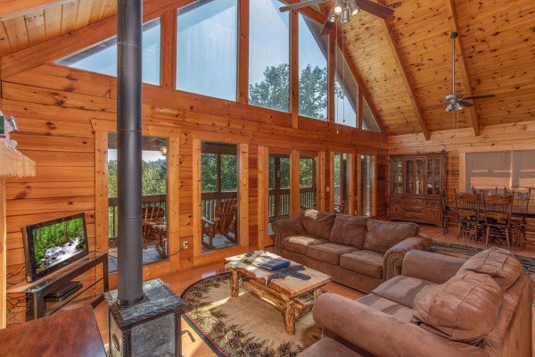 Vaulted ceiling with floor to ceiling windows in the living room at Leconte View Lodge, a 3 bedroom cabin rental located in Pigeon Forge