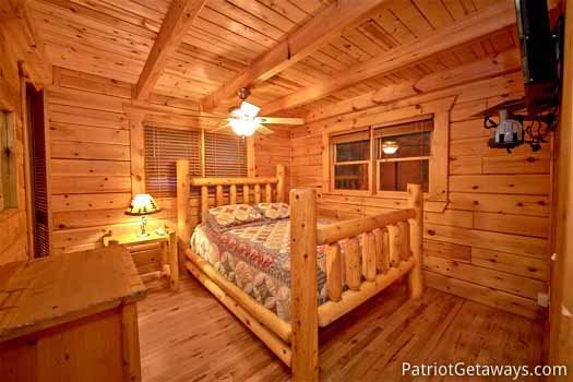 Main level bedroom with queen sized bed at Black Bear Magic, a 4-bedroom cabin rental located in Gatlinburg