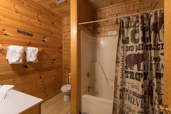 Bathroom with a tub and shower at Mountain Magic, a 1 bedroom cabin rental located in Pigeon Forge