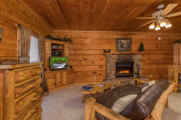 Living room with fireplace and TV at Mountain Magic, a 1 bedroom cabin rental located in Pigeon Forge