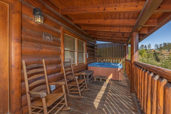 Hot tub and rockers on deck at Rocky Top Memories, a 2 bedroom cabin rental located in Pigeon Forge