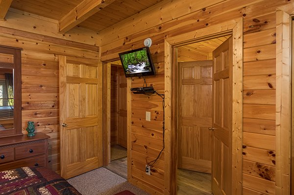 Bedroom with a wall mounted TV at Lake Life, a 4 bedroom cabin rental located in Sevierville