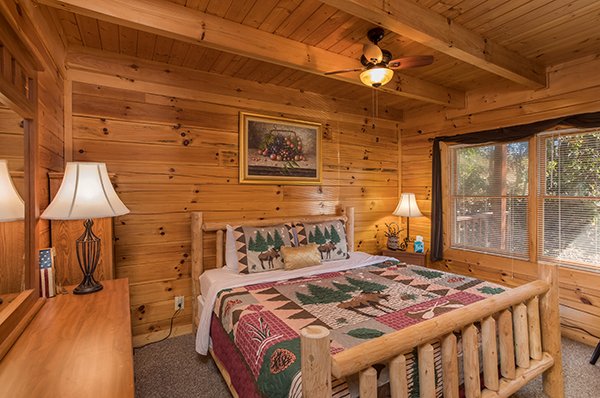 Bedroom with a log bed and dresser at Lake Life, a 4 bedroom cabin rental located in Sevierville