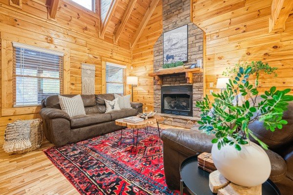 Living room view of fireplace at Happy Hideaway, a 4 bedroom cabin rental located in Pigeon Forge