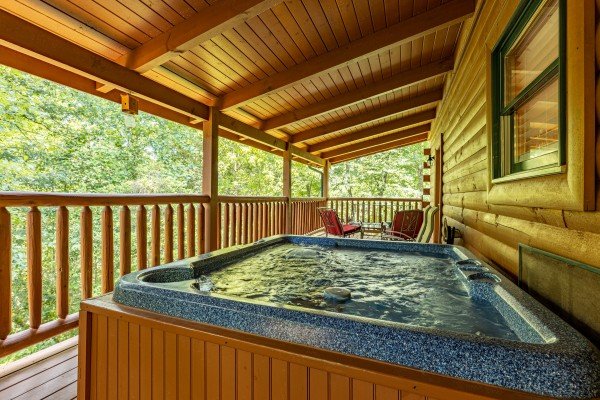 Hot tub on main floor deck at Happy Hideaway, a 4 bedroom cabin rental located in Pigeon Forge