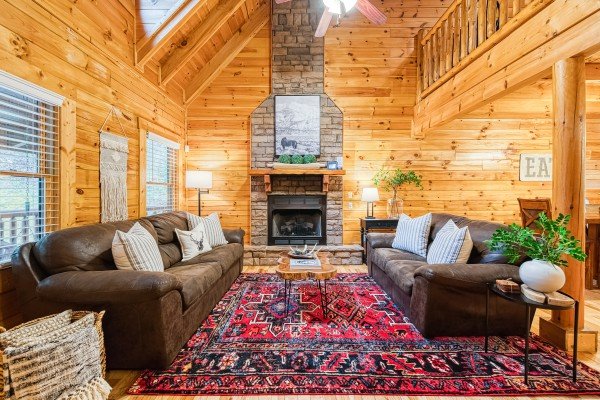 Living room view of the fireplace at Happy Hideaway, a 4 bedroom cabin rental located in Pigeon Forge