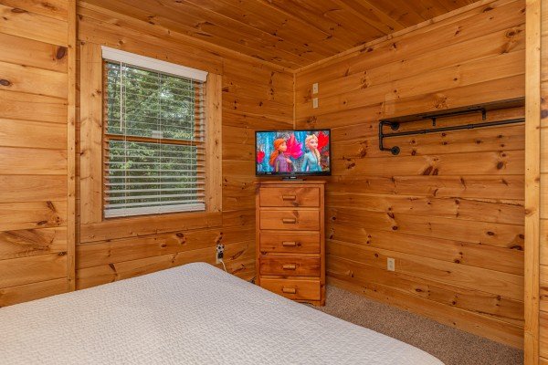 Flat screen in queen bedroom at Happy Hideaway, a 4 bedroom cabin rental located in Pigeon Forge