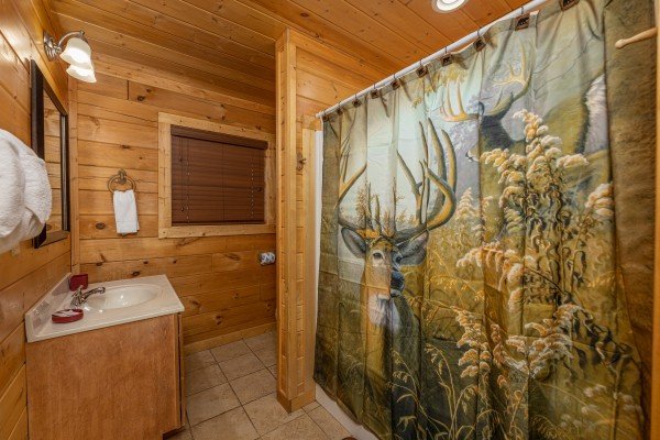 Bathroom with a tub and shower at 3 Crazy Cubs, a 5 bedroom cabin rental located in Pigeon Forge