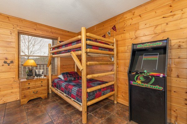 Bunk beds and arcade game at Smoky Mountain Escape, a 3 bedroom cabin rental located in Pigeon Forge